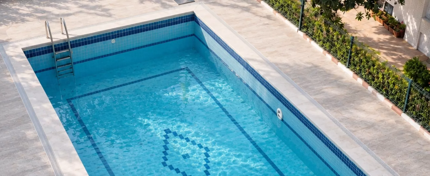 Same pool after remodel with waterfall, raised spa and LED lighting
