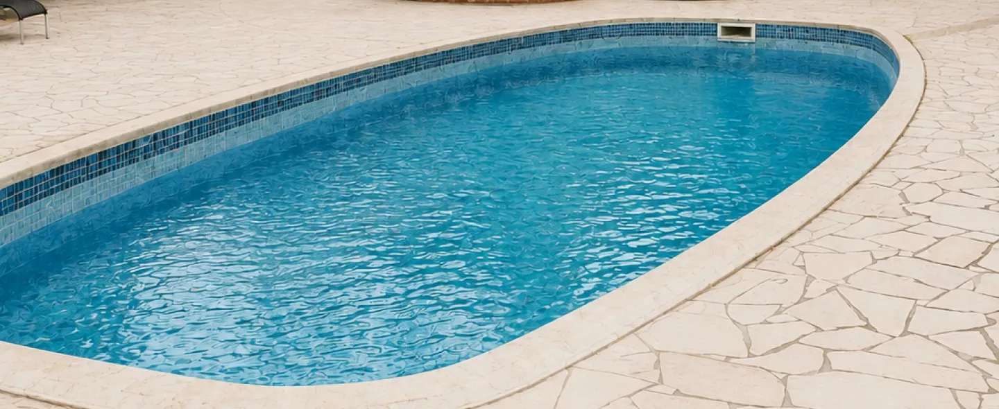 Same pool after renovation with fresh finish, new tile and paver deck