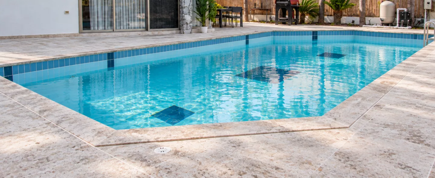 Same backyard pool after repair with clear water and refreshed equipment pad