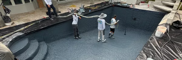 Steel-reinforced concrete pool shell freshly shaped in a Florida backyard