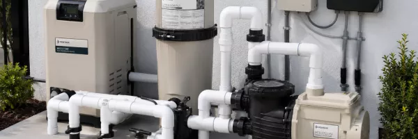 Modern pool equipment pad with new pump, filter, and clean plumbing lines