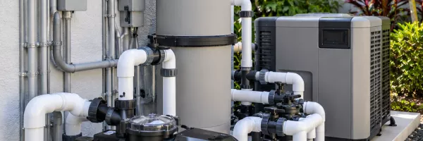 Modern pool equipment pad with variable-speed pump, filter, and automation panel
