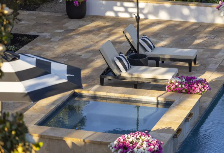 South Florida backyard pool edged with travertine coping and palms