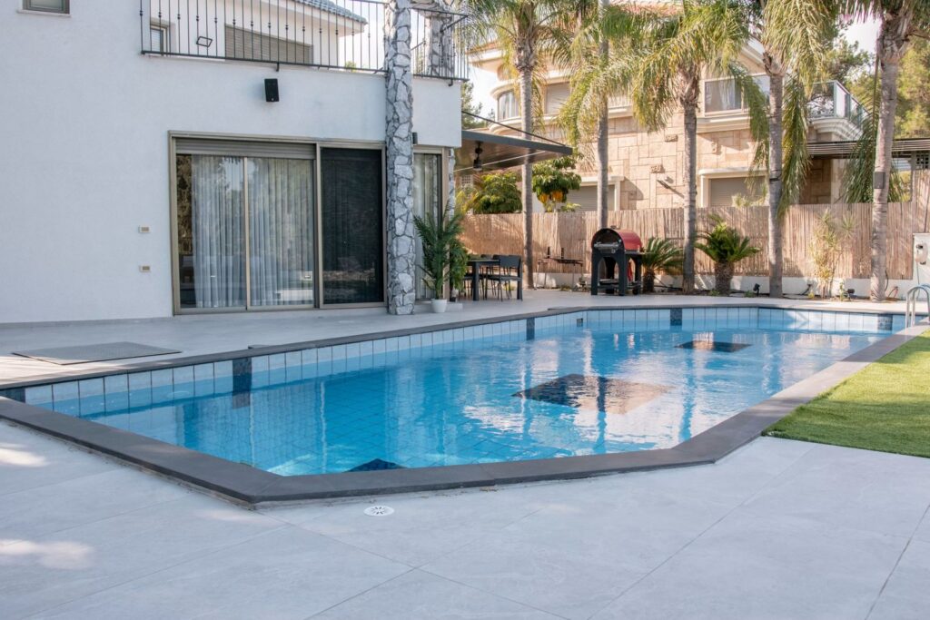 Contemporary Curvilinear Pool Featuring an Elevated Spa
