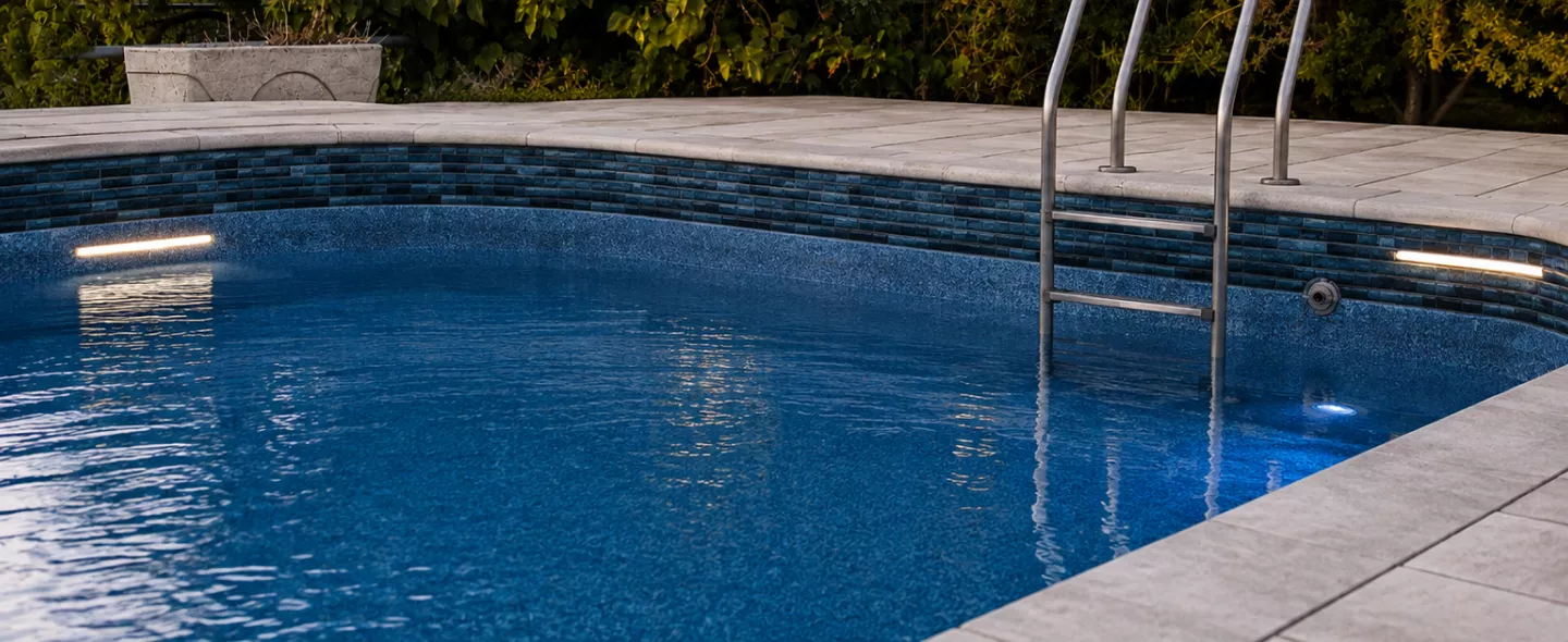 Freshly resurfaced blue pebble finish pool filled and ready for swimming