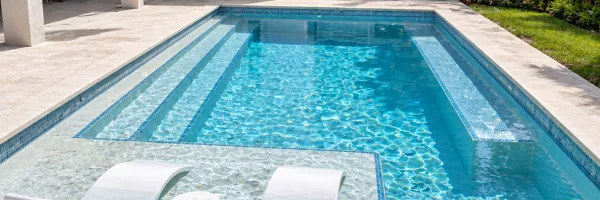 Baja tanning shelf with sun bench and wide entry steps in remodeled pool