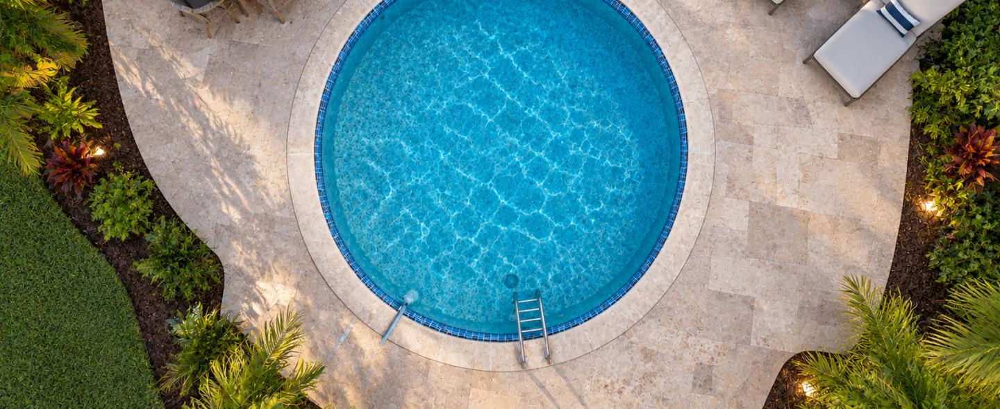 Finished custom residential pool with tanning ledge in landscaped Palm Beach backyard