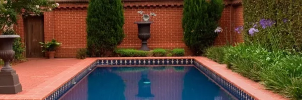 Traditional brick coping installed around a residential swimming pool