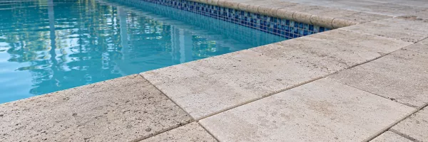 New matching pavers replacing cracked ones on a pool deck