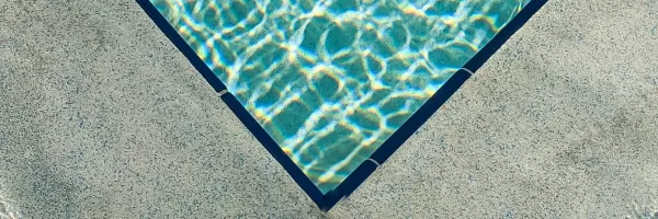 Precast concrete coping with a finished edge installed around an inground swimming pool