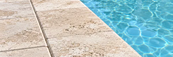 Realigned pool coping stones fitting tightly against an even deck